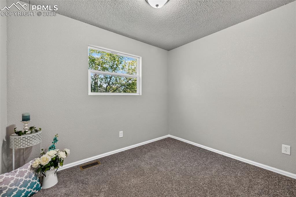 Image 21 of 46: The secondary bedroom on the upper level.