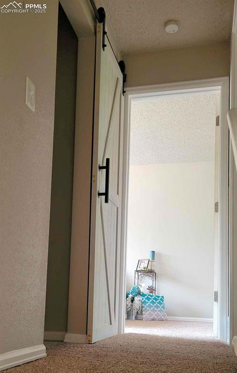 Image 23 of 46: A barn door on the half bath. 