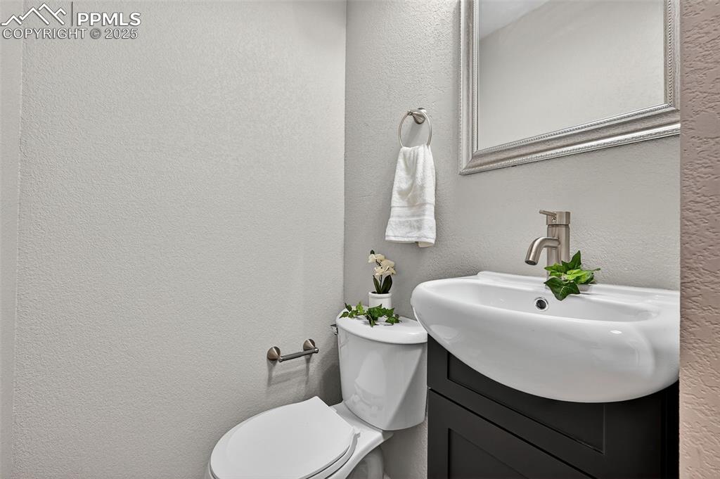 Image 24 of 46: The half bath on the upper level. There is a barn door on this bathroom als