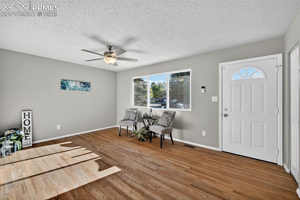 Image 3 of 46: Looking back at the front door from the kitchen. A coat closet next to the 