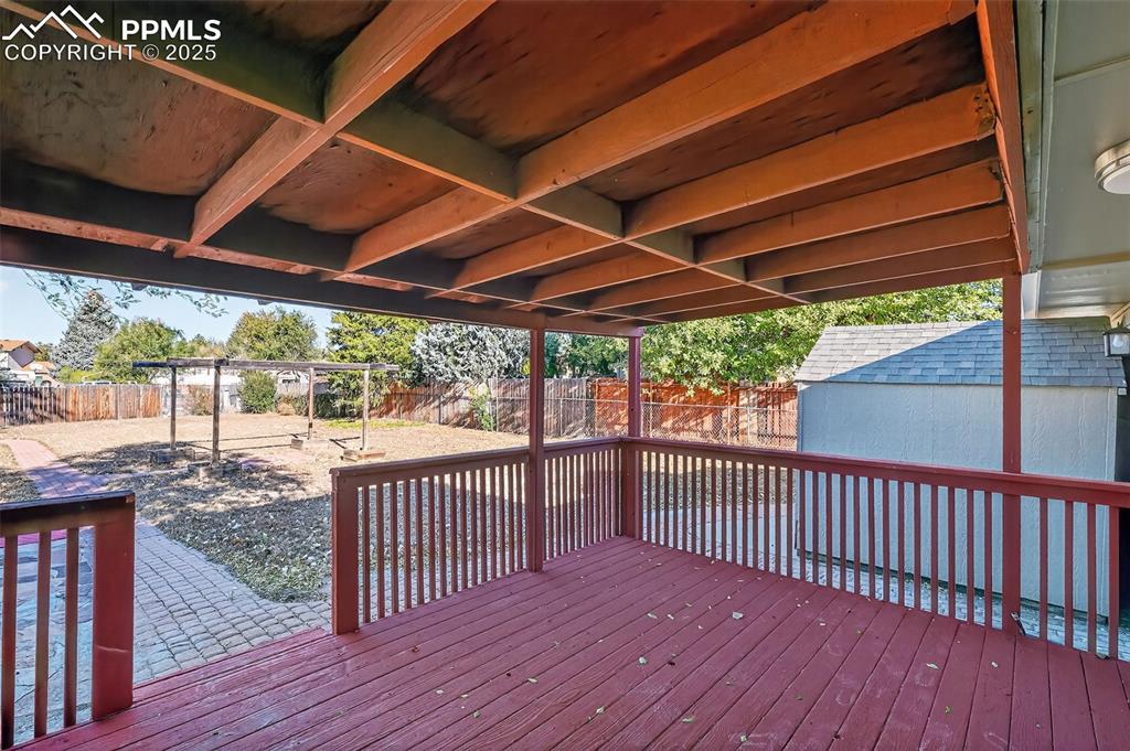 Image 32 of 46: Out under covered deck. Imagine enjoying the summer days out here!