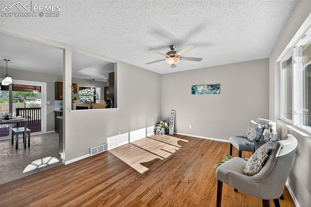 Image 5 of 46: Standing at the front door and looking into the kitchen and dining area. 