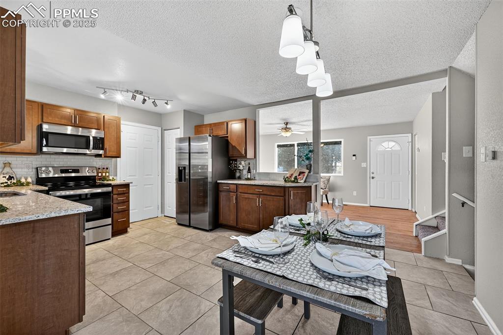 Image 7 of 46: The entrance to the garage and a pantry shown in this picture. The dining a