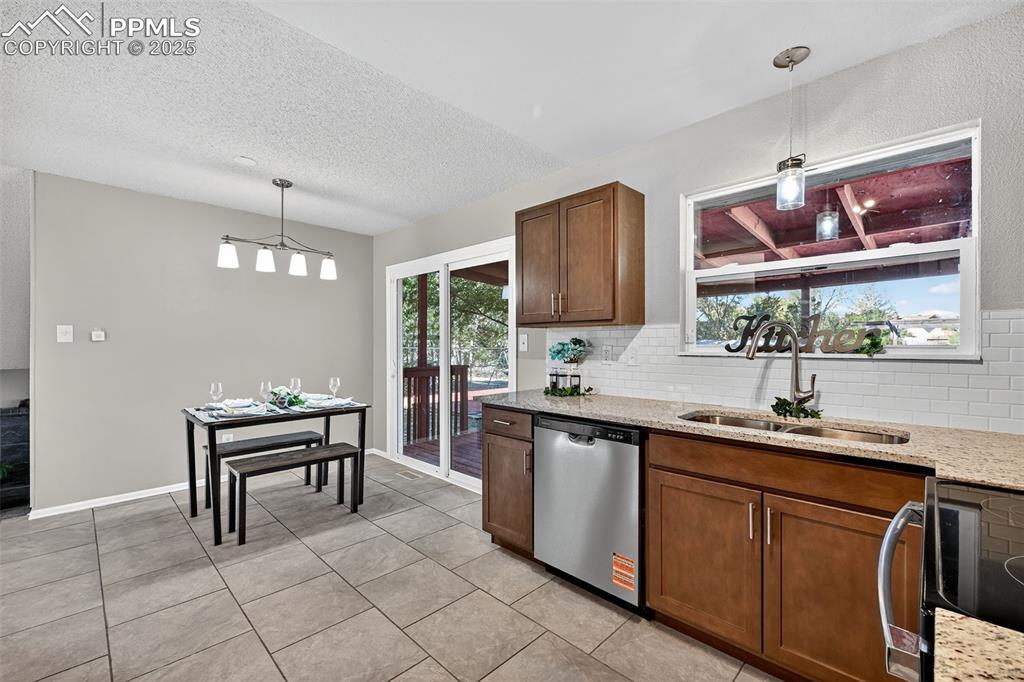 Image 9 of 46: Another view of the kitchen. Custom tile backsplash.