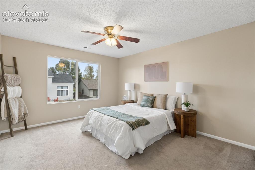 Image 15 of 26: Neutral-toned room featuring wall-to-wall carpeting, a multi-pane window, a