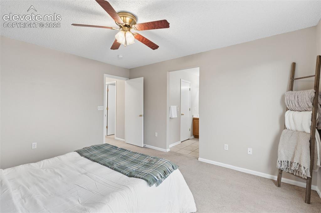 Image 16 of 26: Neutral-toned interior space featuring a brass-finish ceiling fan with wood