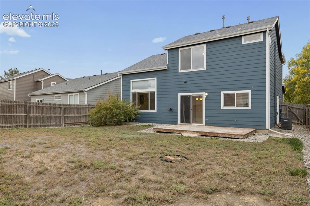Image 26 of 26: Two-story exterior featuring blue horizontal siding, a rear wood deck, mult