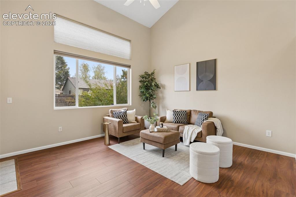 Image 4 of 26: Vaulted ceilings featuring a high-reaching design, wood-finish flooring, an