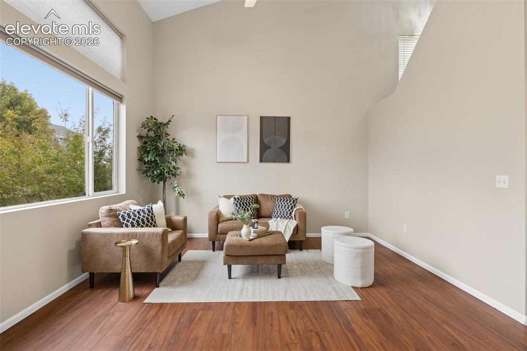 Image 5 of 26: Vaulted ceilings, expansive windows, and wood-finish flooring