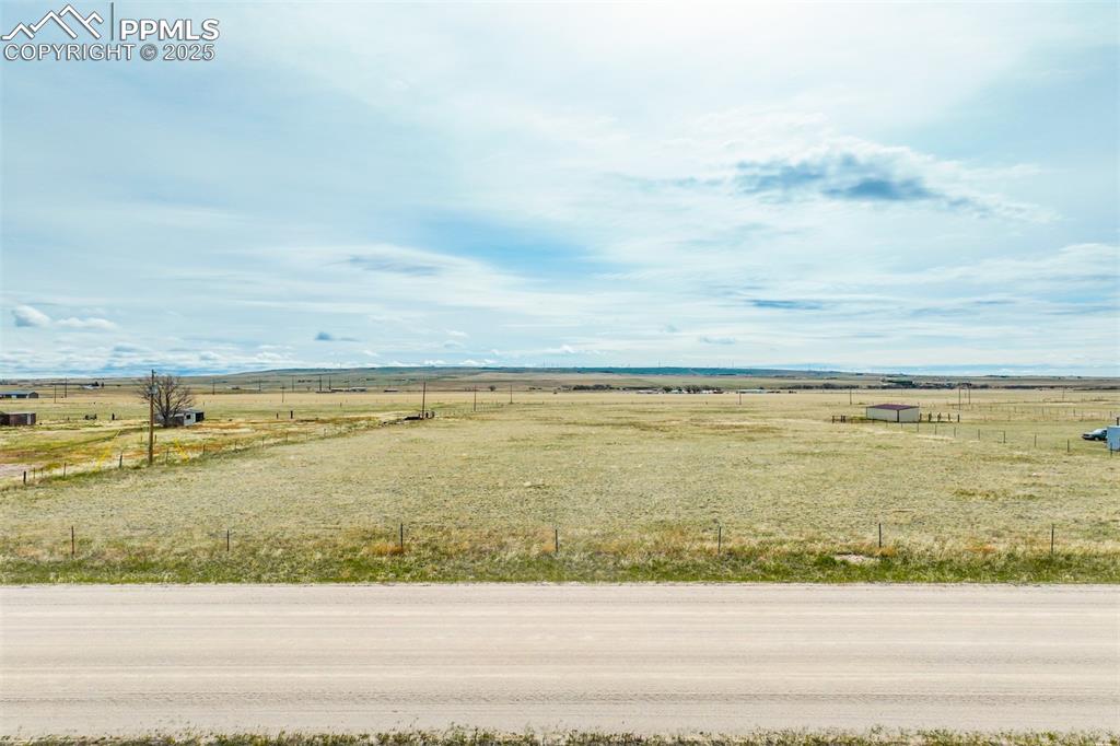 Image 4 of 25: View of yard with fence and a rural view