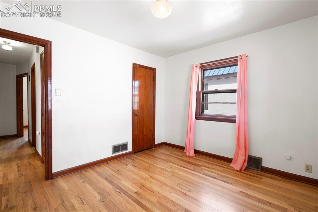 Image 11 of 21: Unfurnished bedroom with light wood-type flooring and a closet