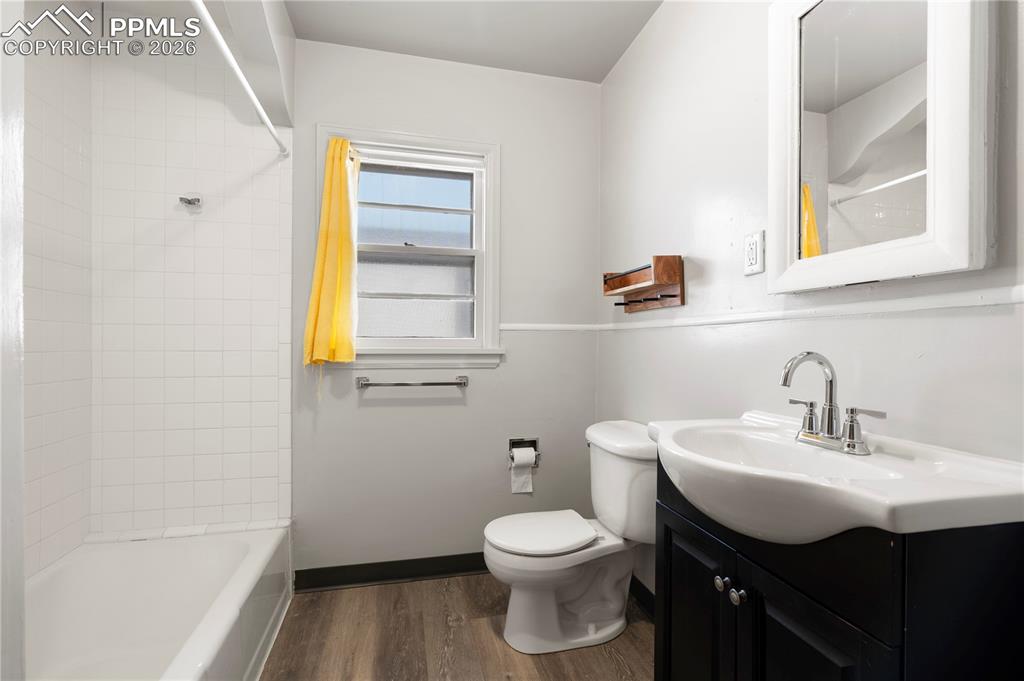 Image 13 of 21: Bathroom featuring vanity, dark wood finished floors, and shower / washtub 