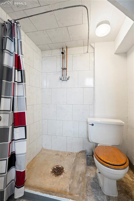 Image 9 of 21: Bathroom with a stall shower and toilet