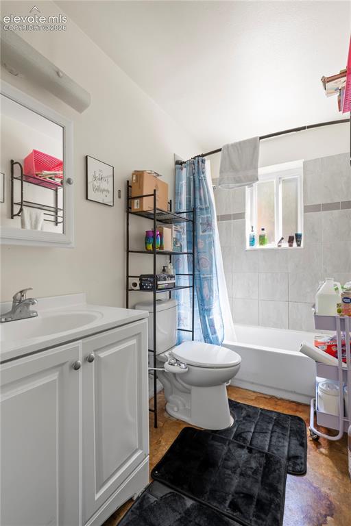 Image 25 of 32: Bathroom featuring a white vanity with an integrated sink, a white toilet, 