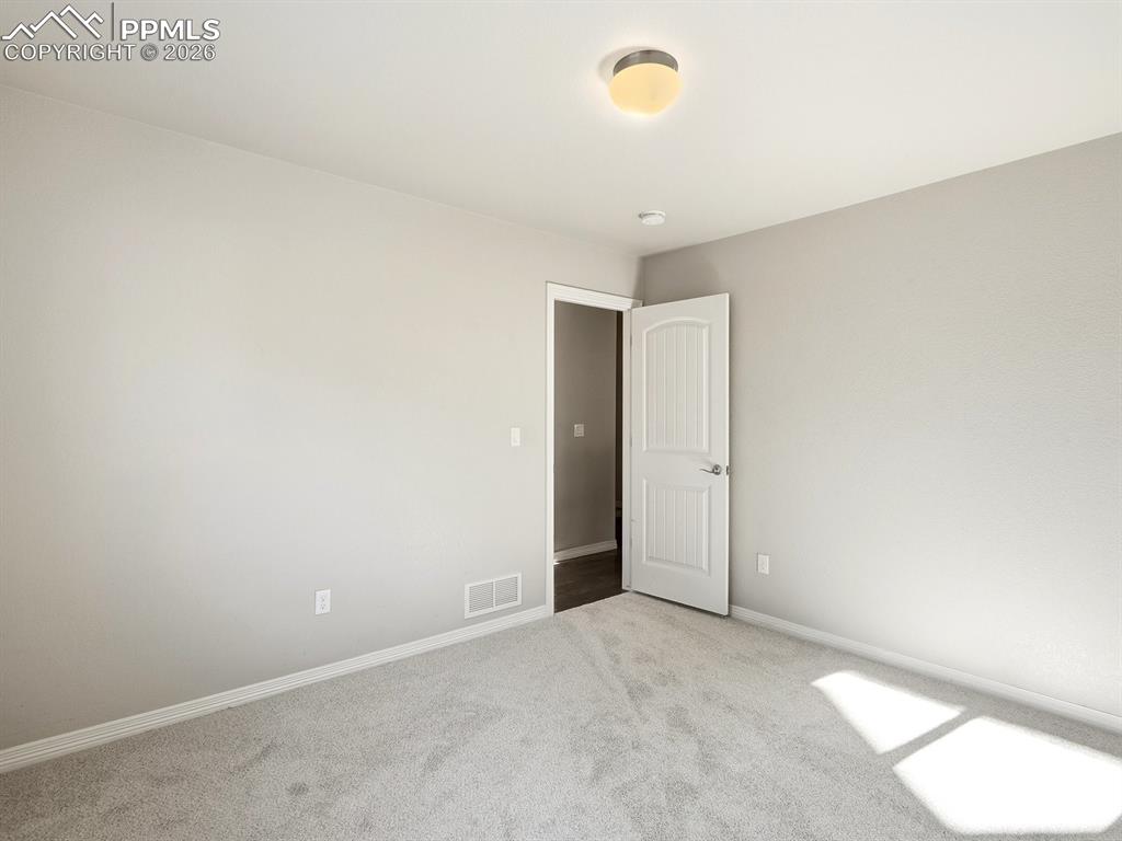 Image 25 of 49: Spacious, light-filled second bedroom ideal for guests