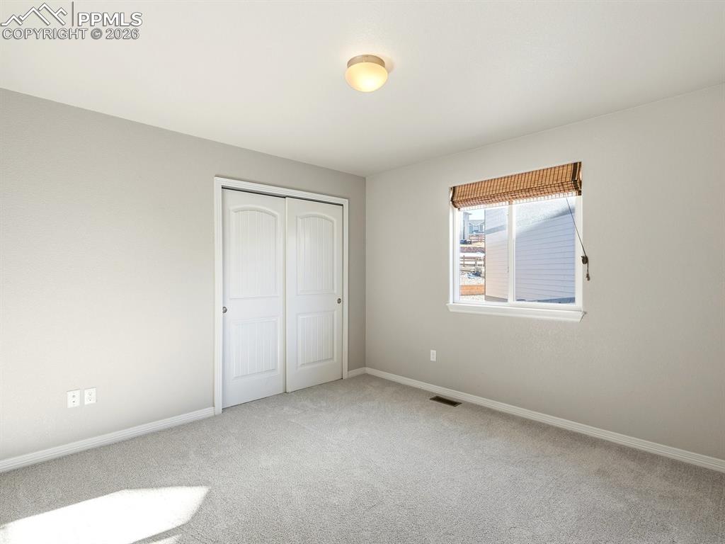 Image 26 of 49: Spacious, light-filled second bedroom ideal for guests