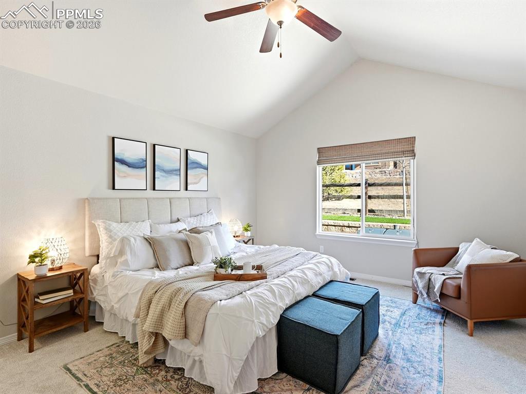 Image 27 of 49: Spacious and bright primary suite highlighted by vaulted ceilings and abund