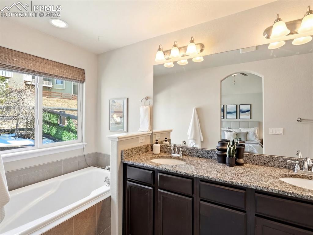 Image 29 of 49: Elegant en suite five-piece bath complete with a spacious soaking tub