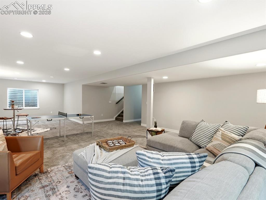 Image 34 of 49: A large media/rec room offering flexible space for entertaining, relaxing,