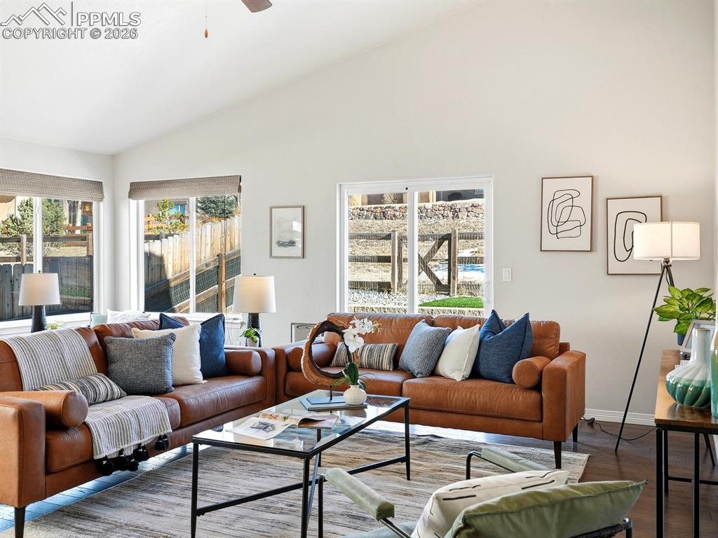 Image 6 of 49: Spacious, light-filled living room with vaulted ceilings and abundant natur
