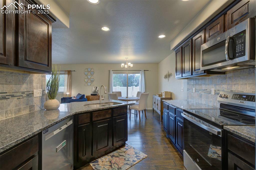 Image 10 of 34: Aerial perspective of suburban area with a mountainous background