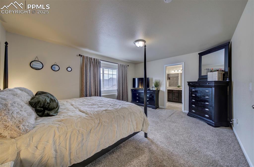 Image 15 of 34: Bedroom featuring carpet and ensuite bath
