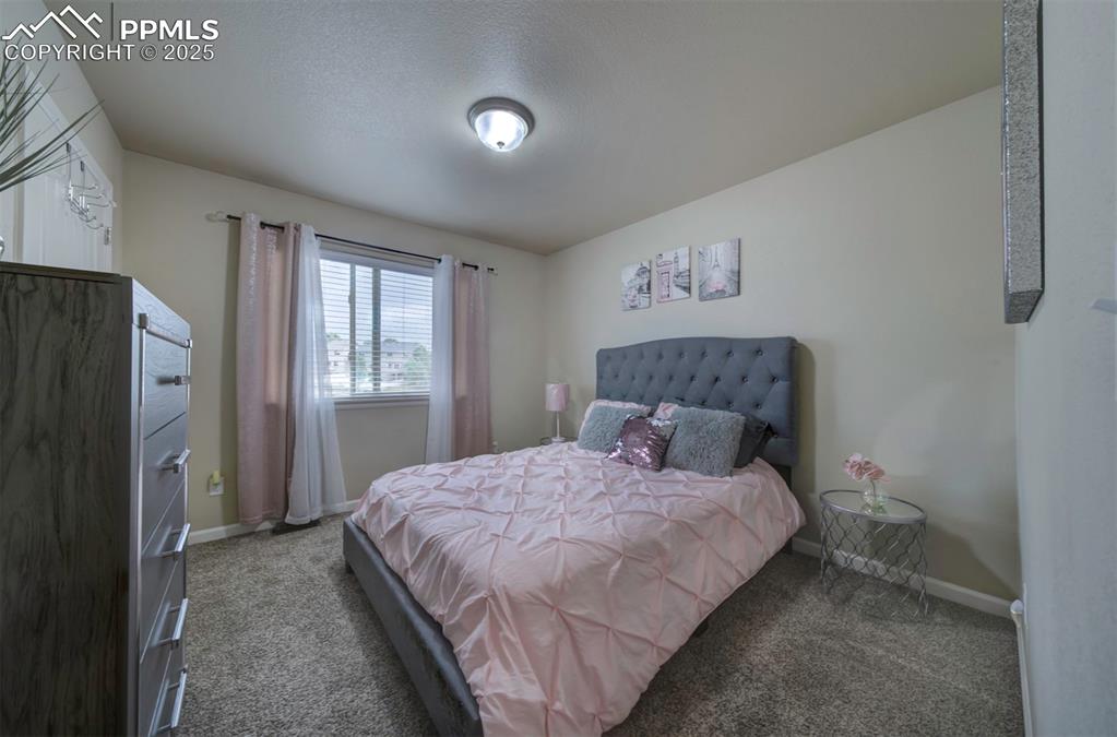Image 19 of 34: Bedroom with carpet flooring and baseboards