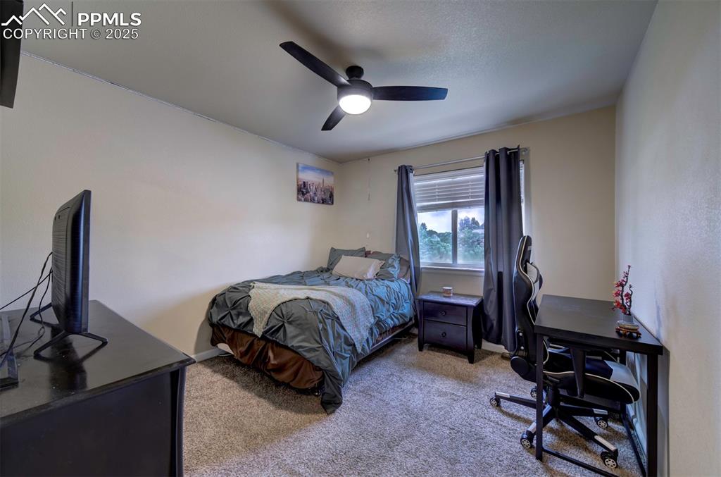 Image 20 of 34: Bedroom on upper level with carpet flooring