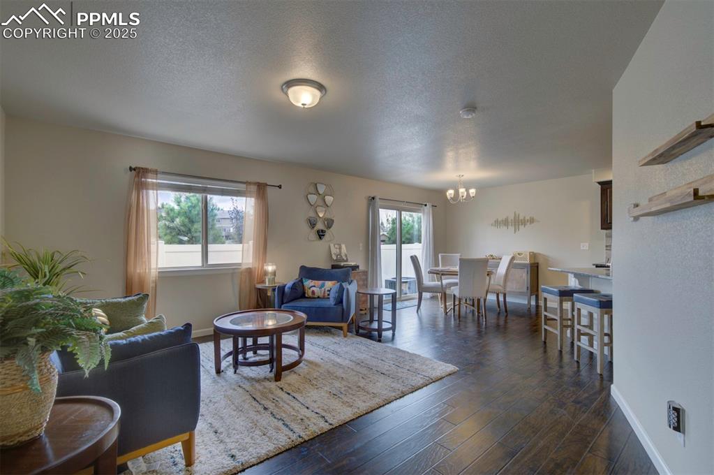 Image 4 of 34: Living room featuring plenty of natural light, walk-out to the patio, wood 