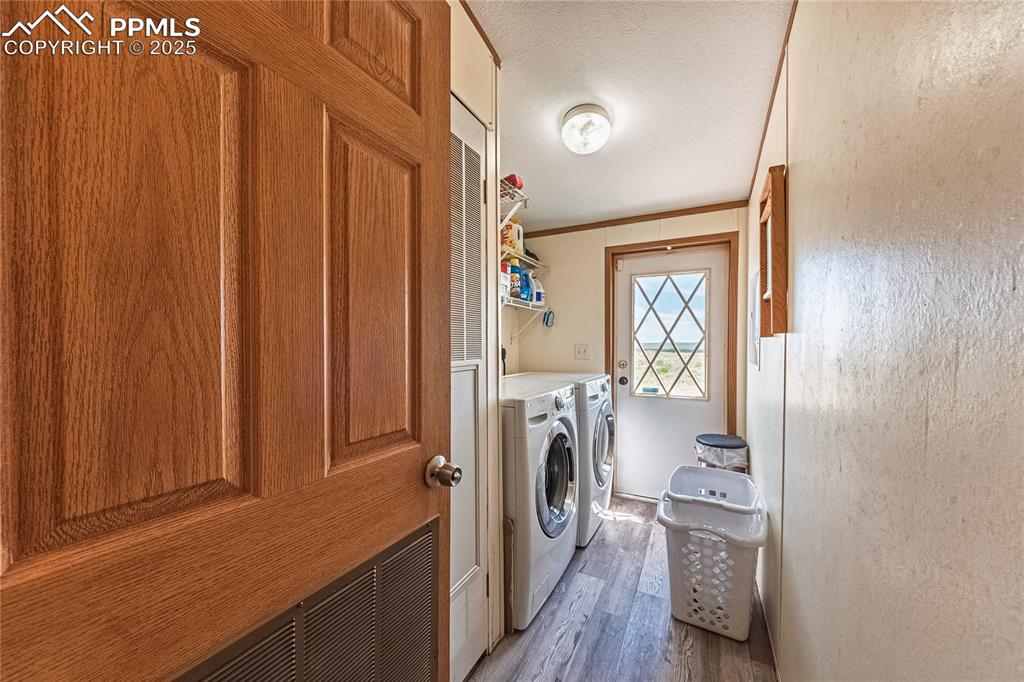 Image 13 of 48: Laundry room featuring separate washer and dryer, light wood finished floor