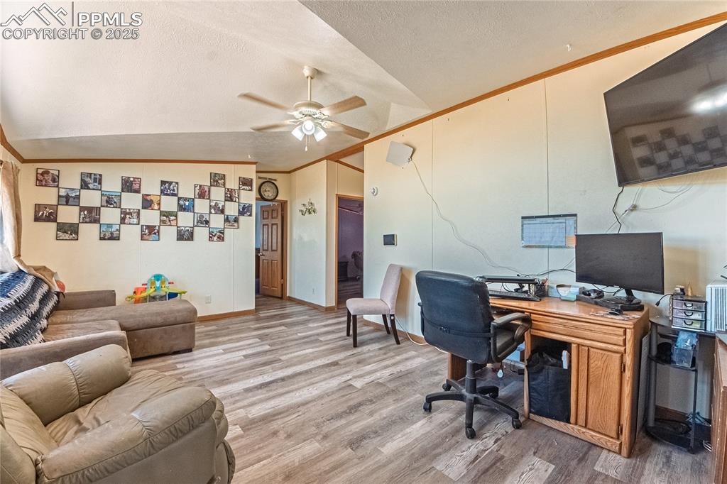 Image 14 of 48: Office area featuring vaulted ceiling, light wood-style flooring, ceiling f