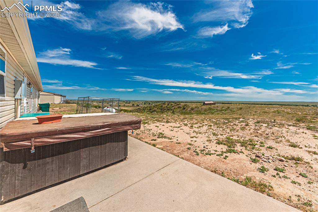 Image 29 of 48: View of patio / terrace featuring a hot tub