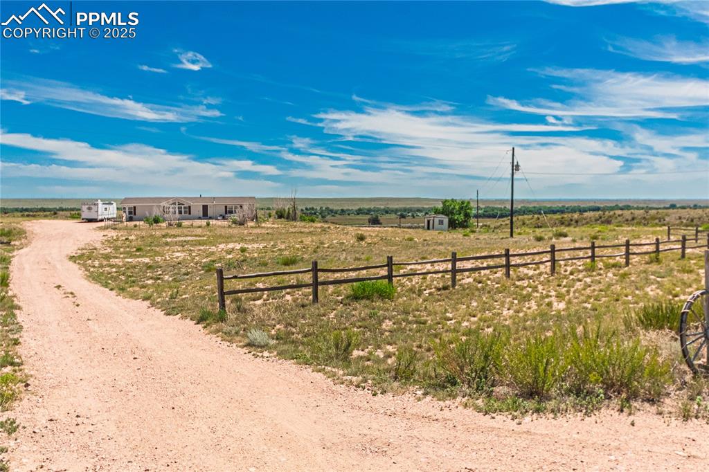 Image 46 of 48: View of dirt / gravel driveway with a view of countryside