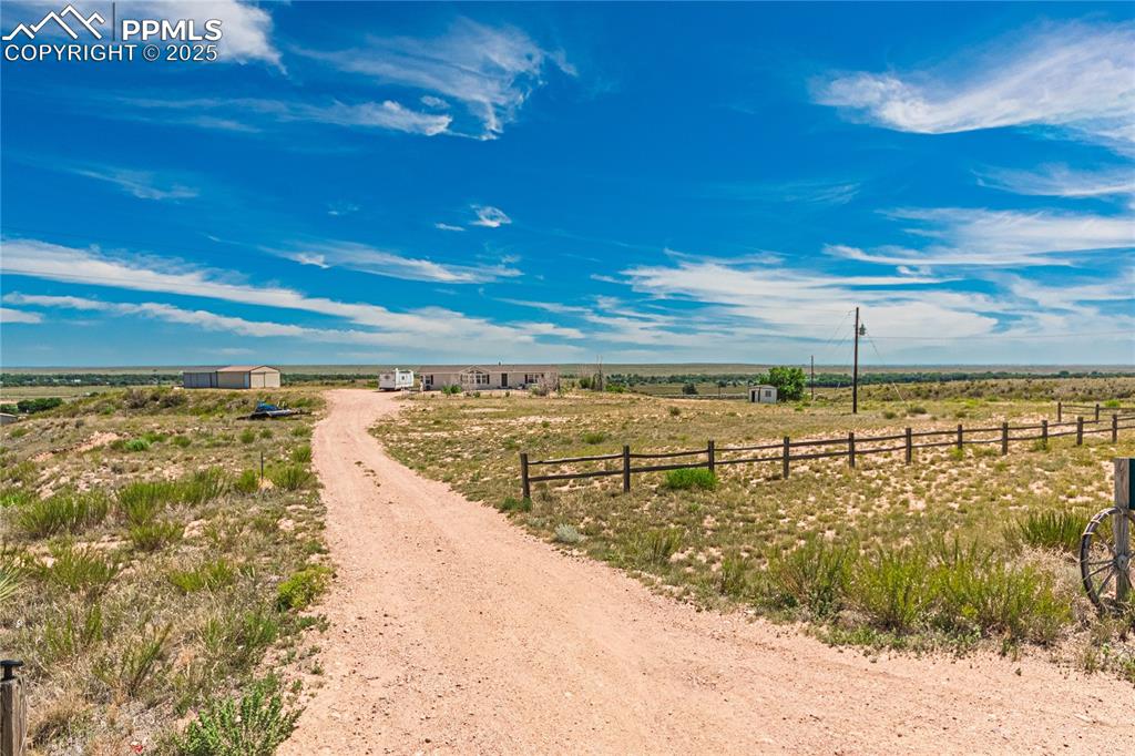 Image 47 of 48: View of dirt / gravel driveway with a view of countryside