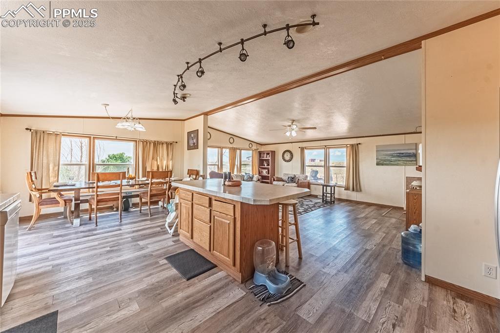 Image 7 of 48: Kitchen with lofted ceiling, crown molding, plenty of natural light, a text
