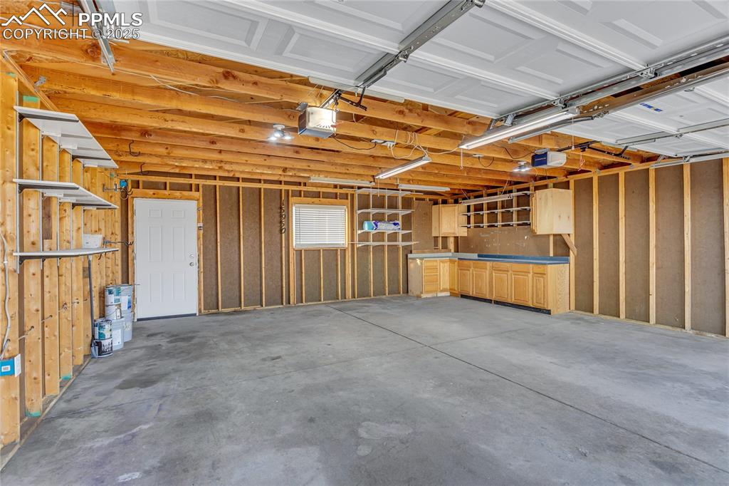 Image 23 of 34: Garage with a garage door opener