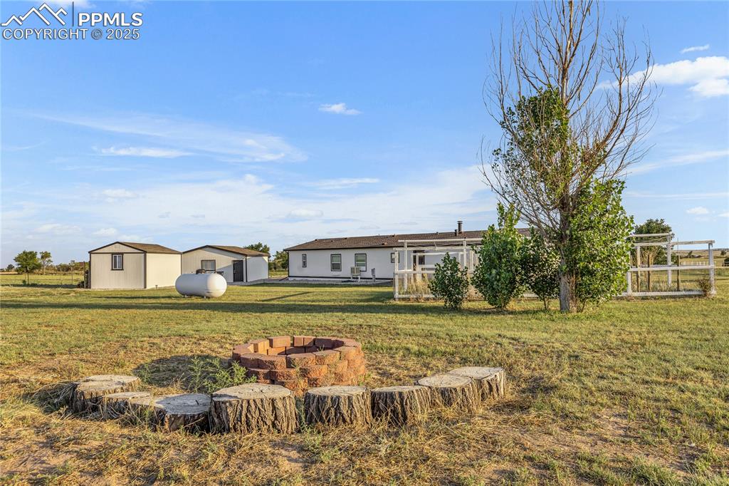Image 28 of 34: View of yard with an outdoor fire pit