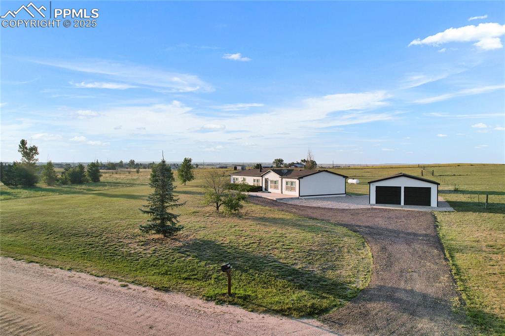 Image 29 of 34: Ranch-style home with a rural view and a front yard