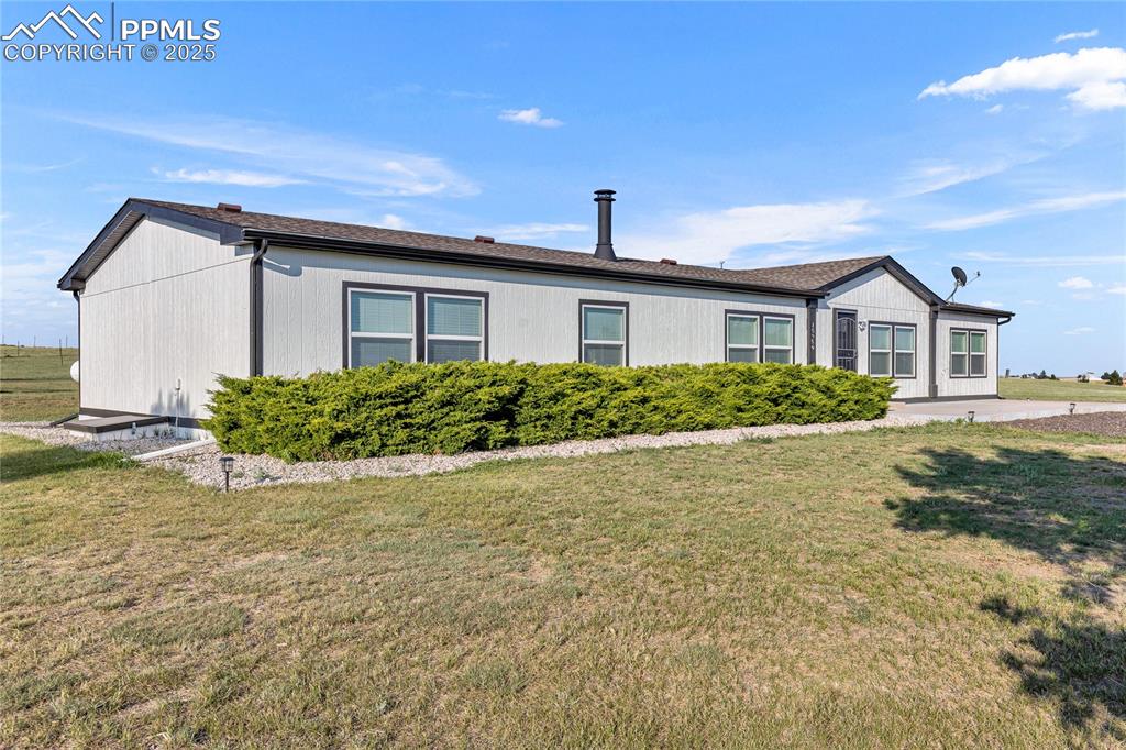 Image 3 of 34: View of front of home with a front lawn