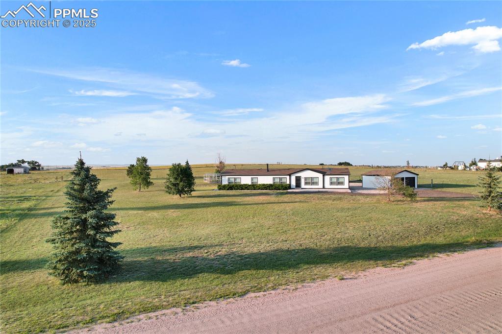 Image 30 of 34: View of front of home featuring a rural view and a front lawn