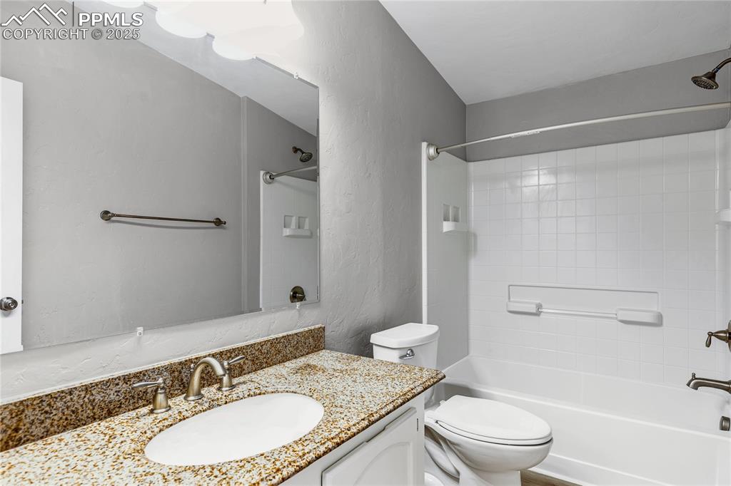 Image 9 of 34: Full bathroom featuring vanity, toilet, and shower / bathtub combination