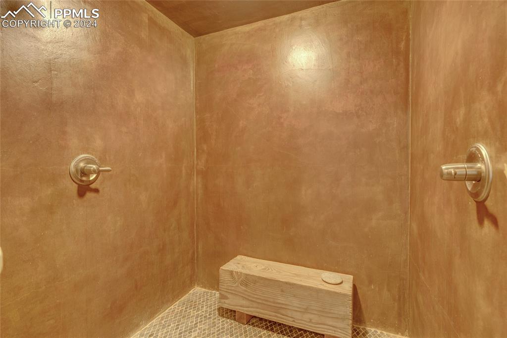 Image 21 of 47: Bathroom featuring tile flooring and a shower
