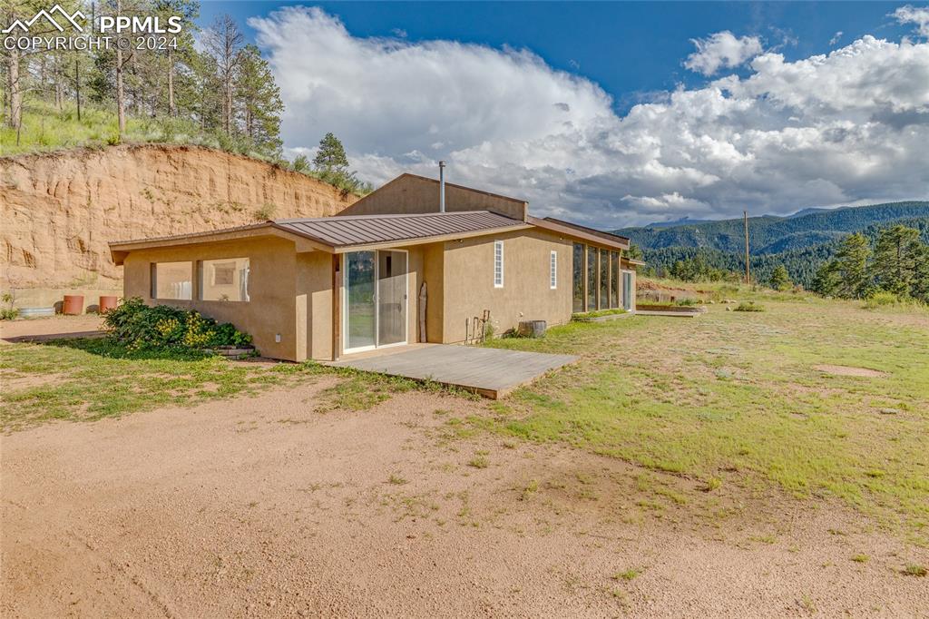 Image 34 of 47: Back of property featuring a patio and a mountain view