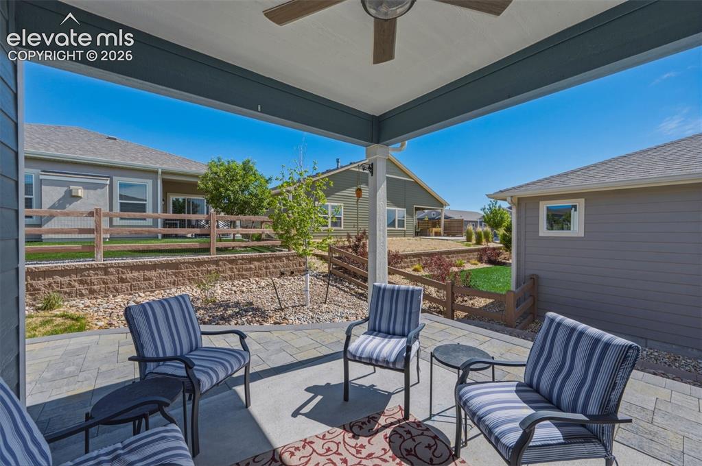 Image 19 of 25: Covered outdoor patio featuring a ceiling fan