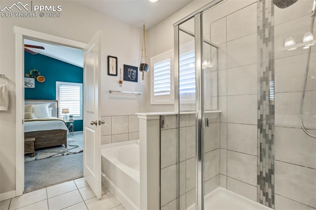 Image 23 of 47: Standing shower with tile accents. 