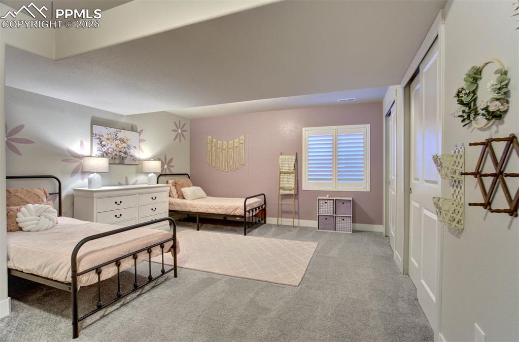 Image 34 of 47: Bedroom 4 in the basement with dual closets. 