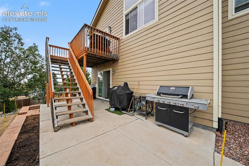 Image 19 of 21: Concrete patio with access to the deck