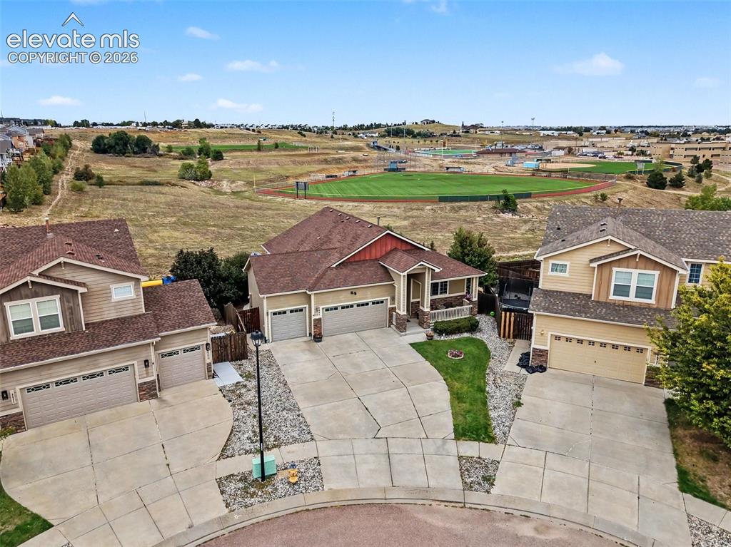Image 20 of 21: View of the cul-de-sac, front of home, open space and school 