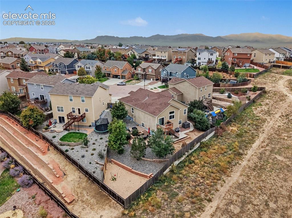 Image 21 of 21: Aerial view of the neighborhood and huge backyard ready for cookouts and re