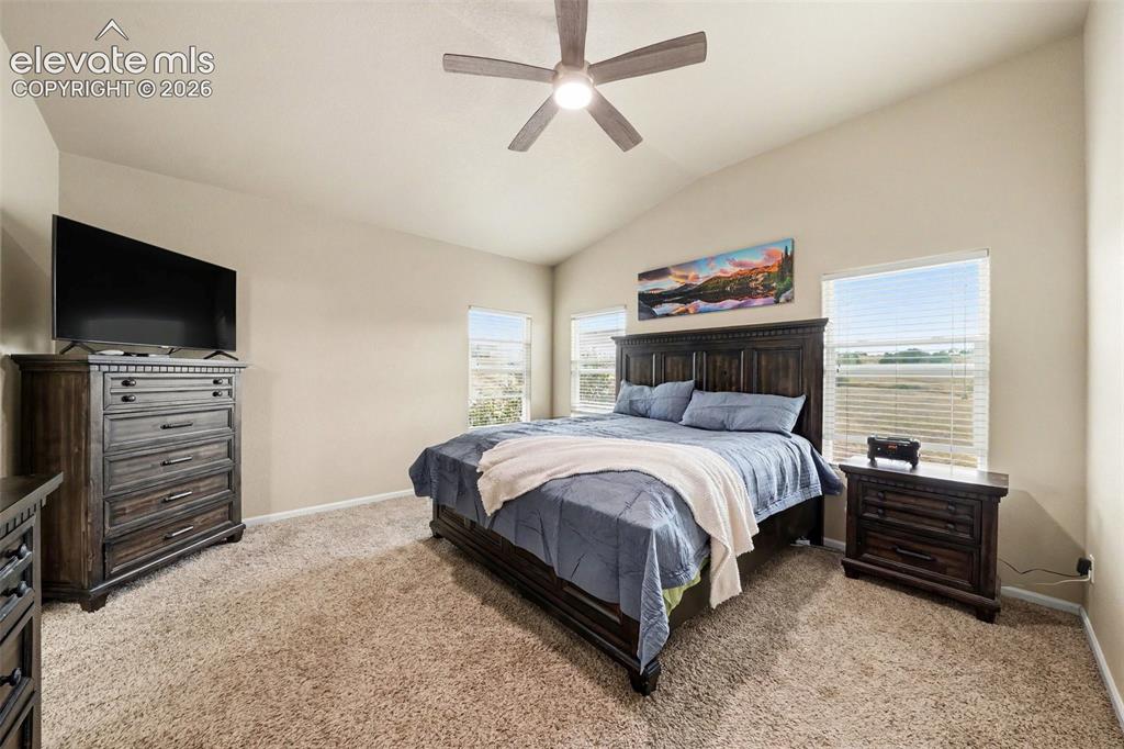 Image 7 of 21: Primary bedroom featuring a vaulted ceiling